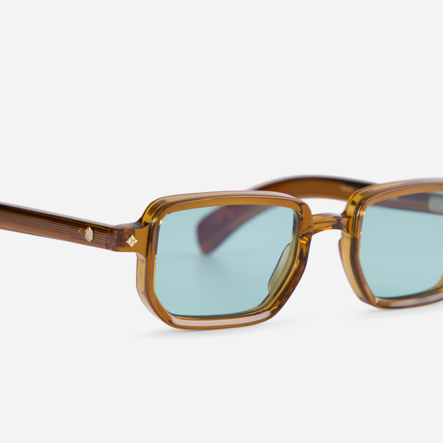 Ran MC-1 features a Japanese acetate frame in Maple Crystal color (clear brown) and Blue flash lenses, offering a modern look.
