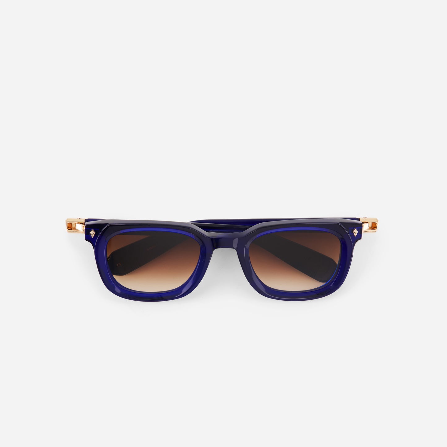 Blue sunglasses with gold accents on a white background