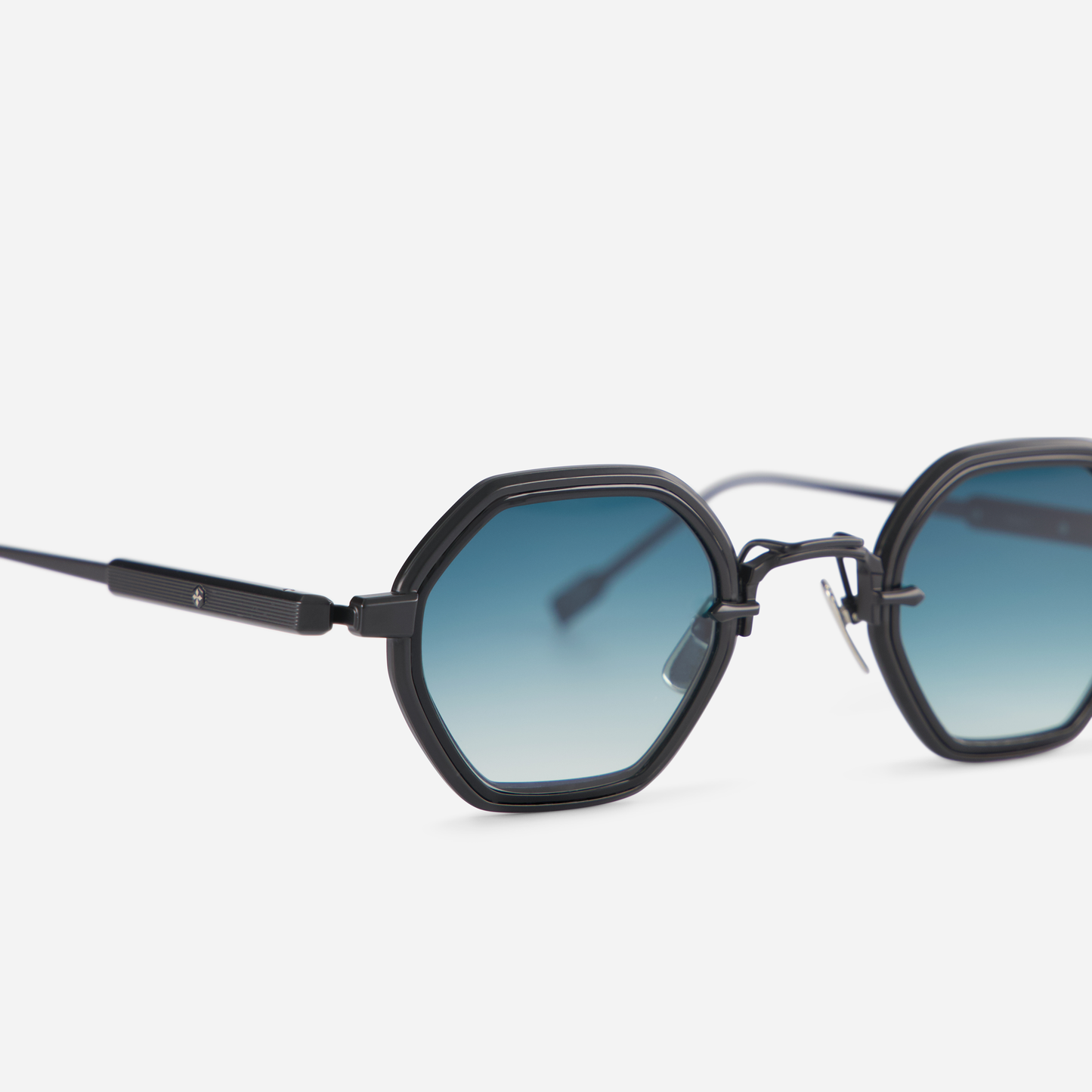 This eyewear, Sato Arraï-T B-1, includes a titanium frame with a black mat coating, a black takiron rim insert, and gradient deep sea blue lens.