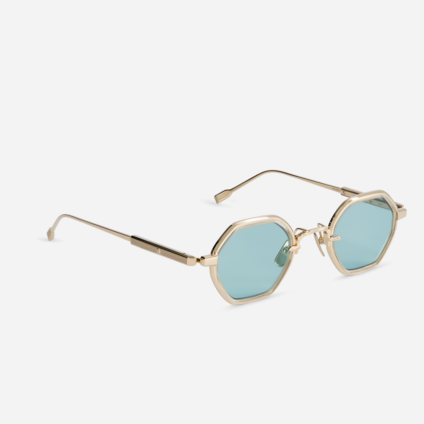 The Arraï-T LG-1 eyeglasses come with a titanium frame, lunar gold coating, honey yellow takiron rim insert, and turquoise lenses.