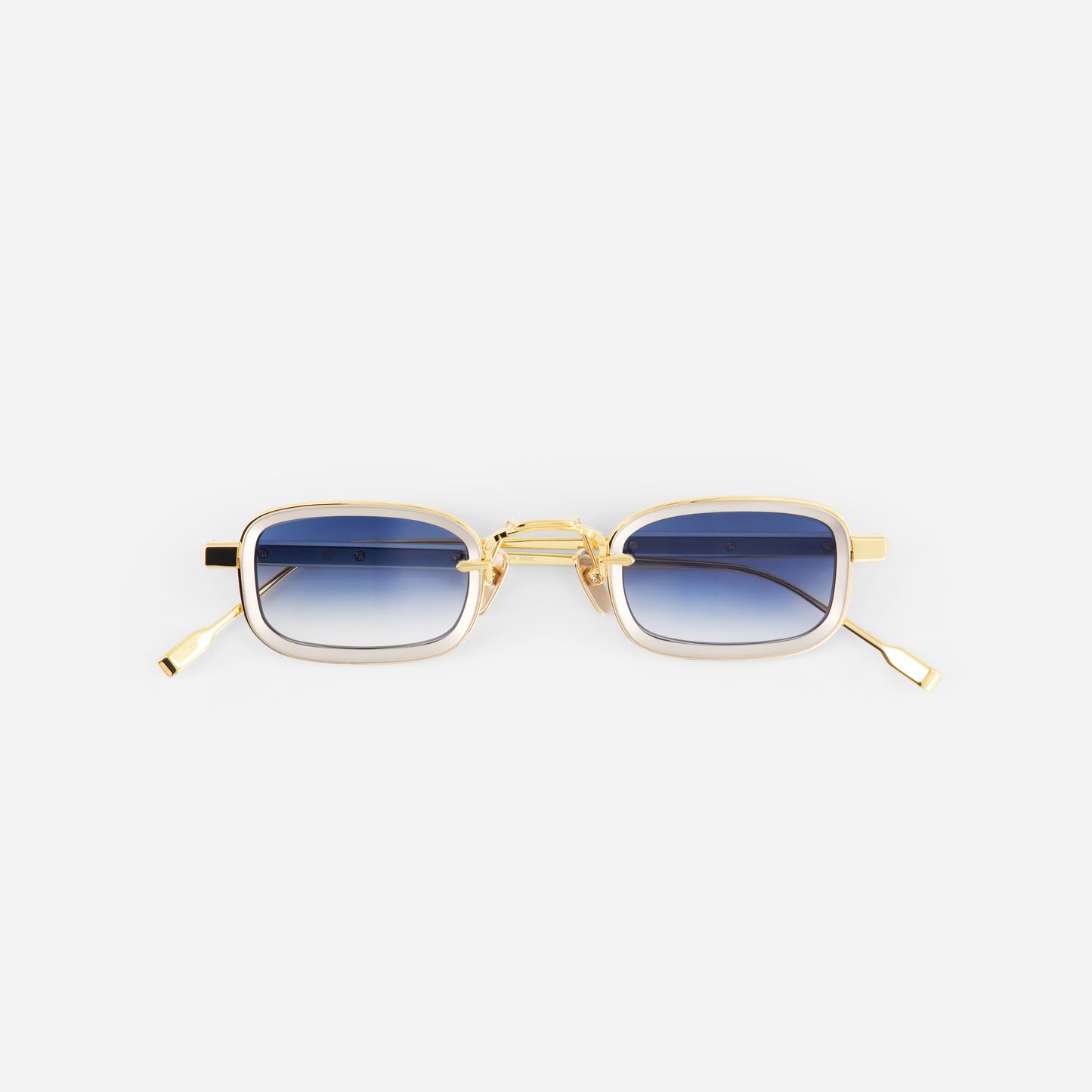 Gold-framed sunglasses with blue gradient lenses on a white background