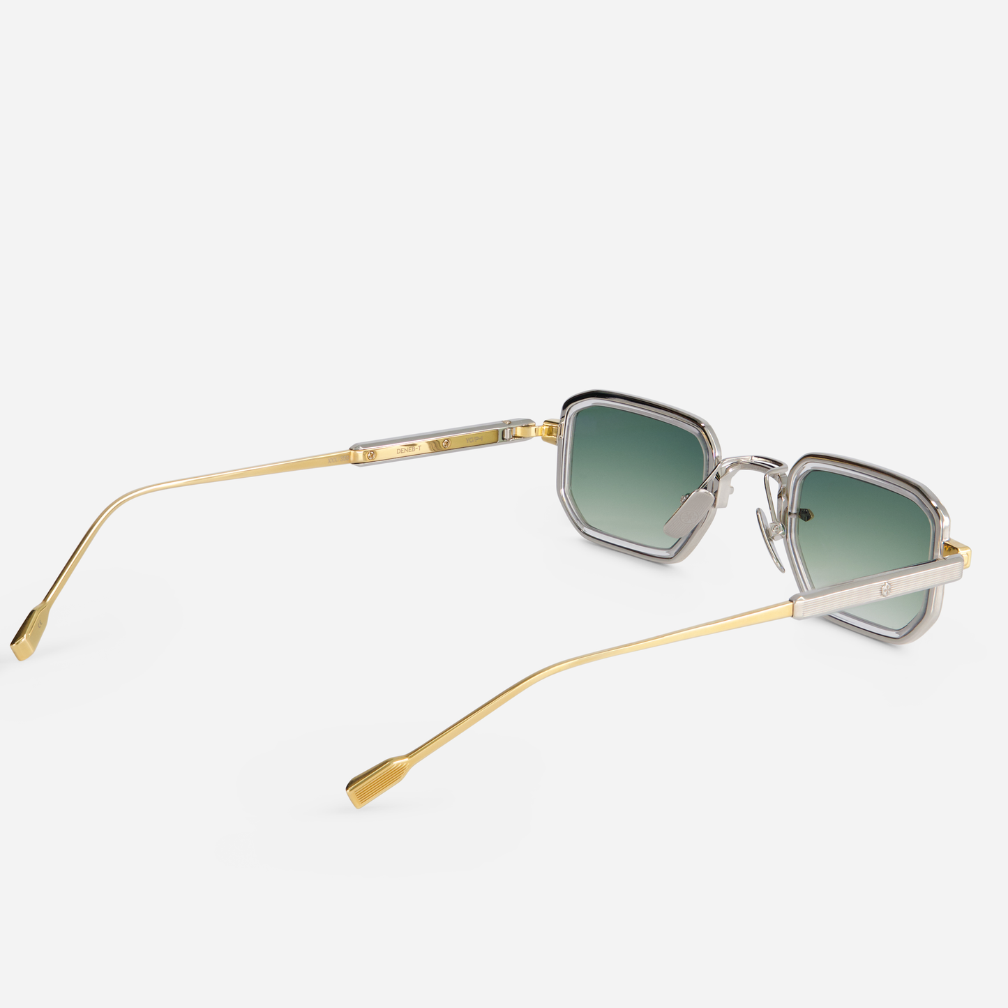 The Deneb-T YG/P-1 eyeglasses are designed with a titanium frame, yellow gold, and platinum coating. They come with a crystal takiron rim insert and gradient green lenses. SATO