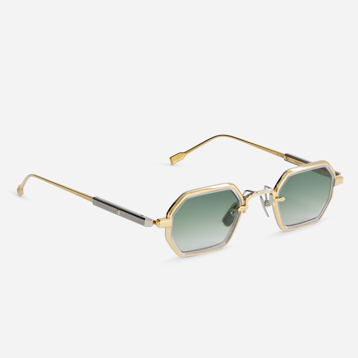 The Hadar-T YG/P-1 eyeglasses come with a titanium frame featuring a yellow gold coating, along with a crystal takiron rim insert and gradient green lenses.