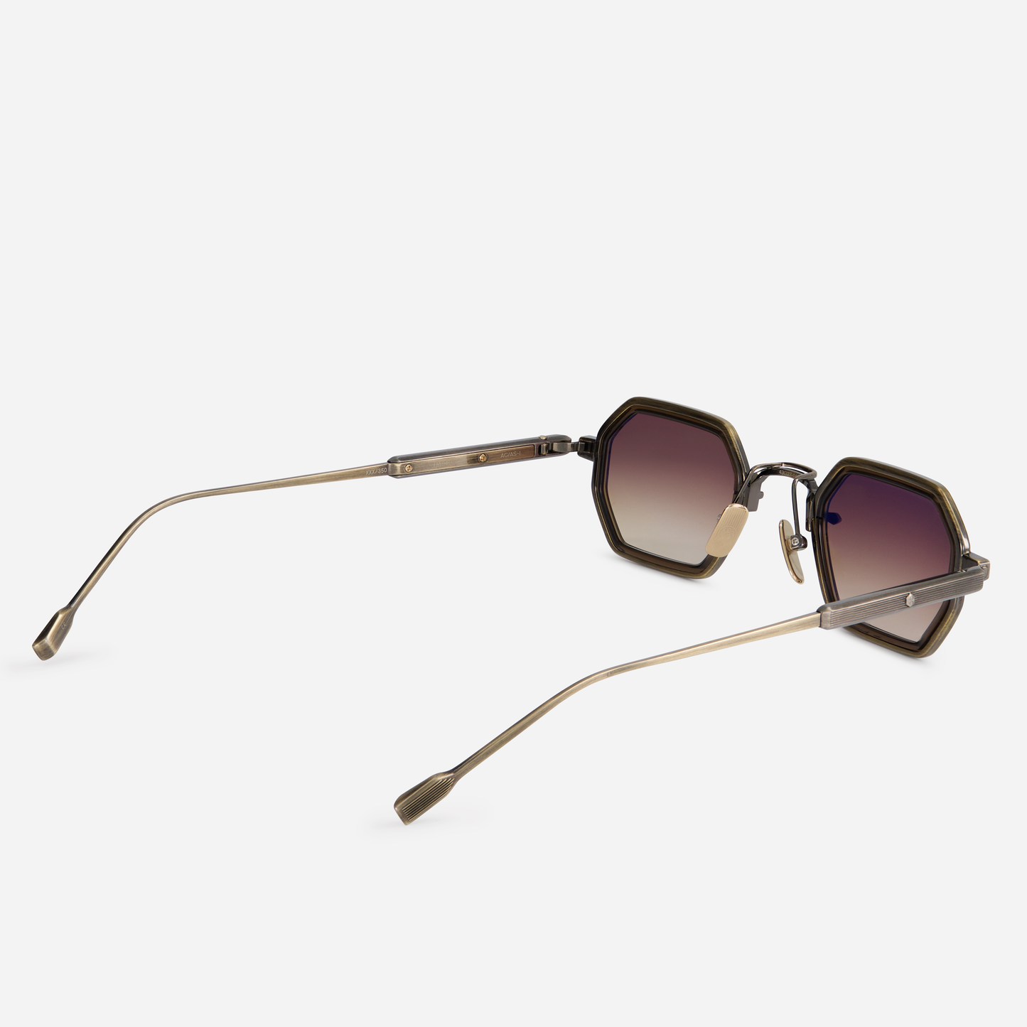 Hadar-T AG/AS-1 eyeglasses come with a titanium frame, antique gold, and antique silver finish, plus a chocolate takiron rim insert and gradient brown lenses.