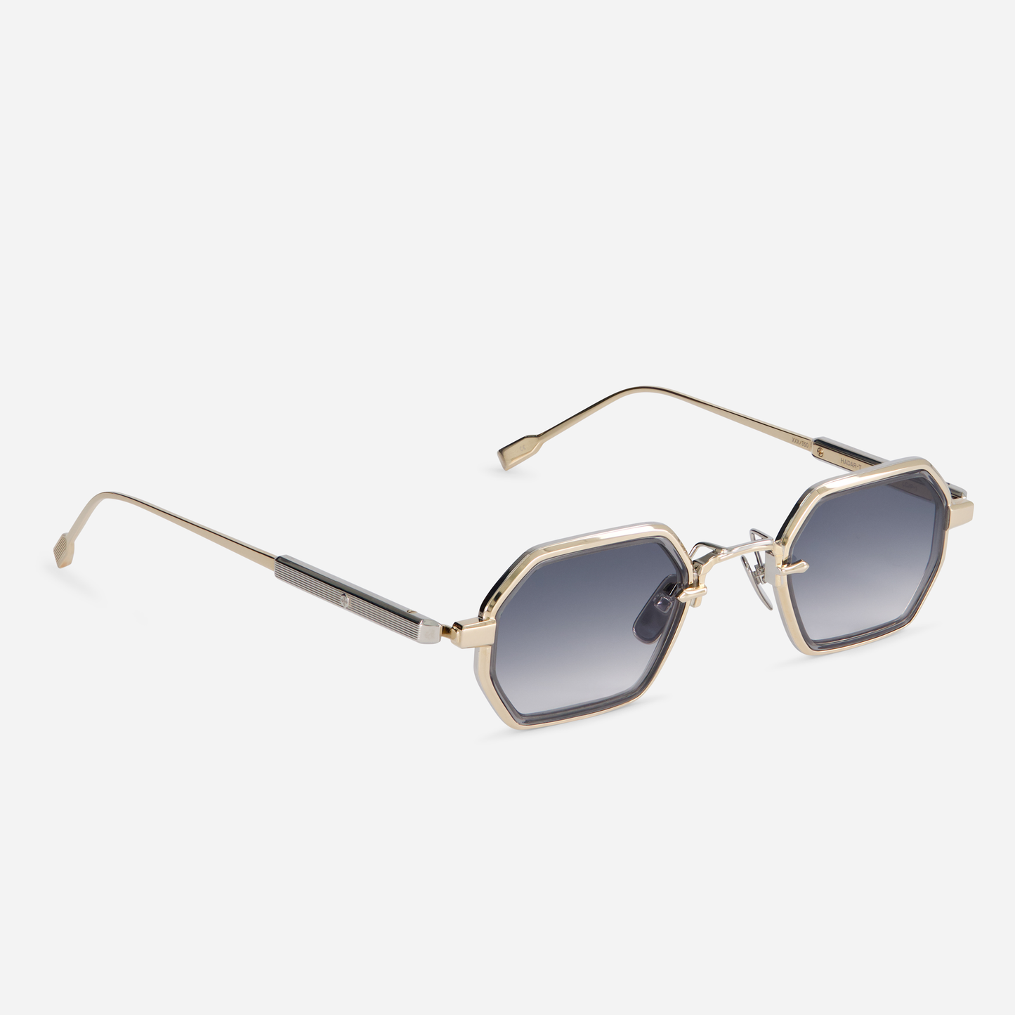 With a titanium frame adorned with lunar gold and platinum coatings, the Hadar-T LG/P-1 eyewear incorporates a crystal grey takiron rim insert and gradient grey lenses.