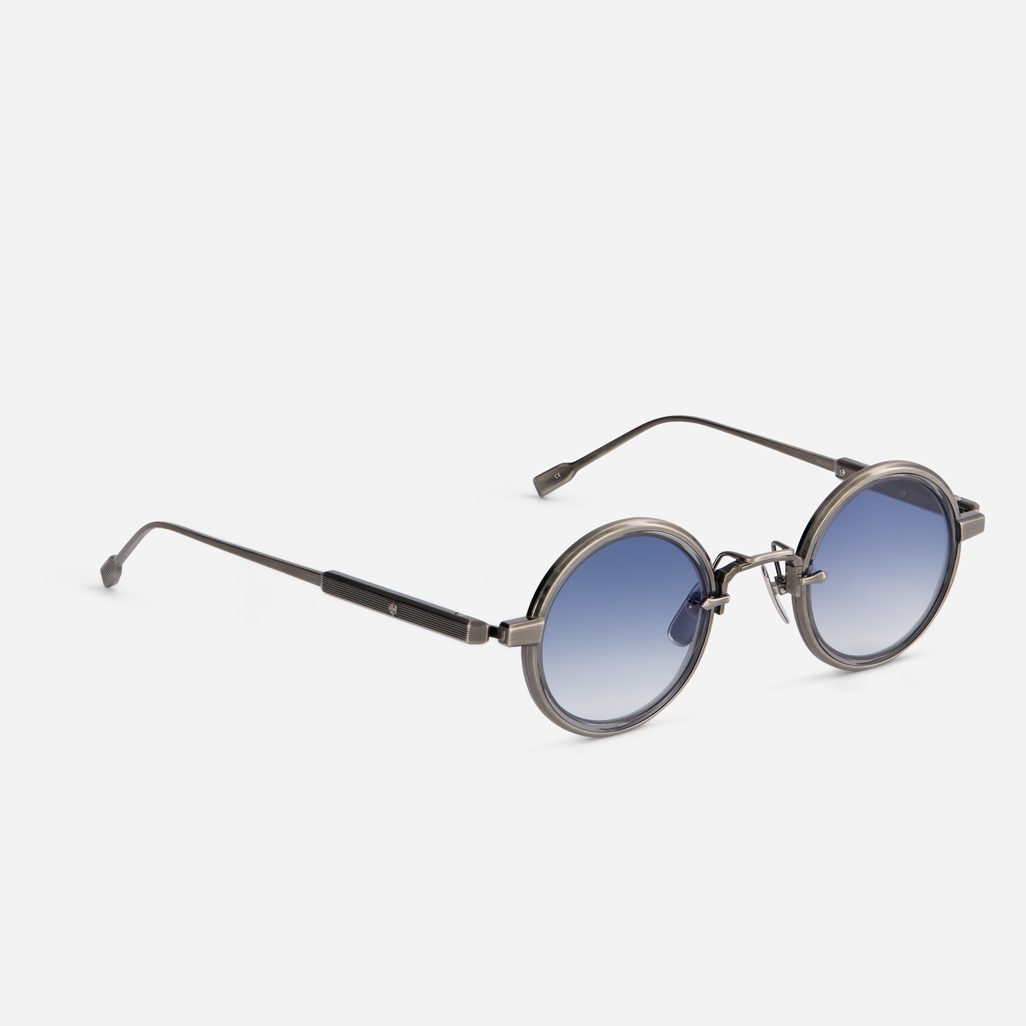 Rotanev-T AS-1 is designed with a titanium frame, antique silver coating, crystal grey takiron rim insert, and gradient blue lenses.