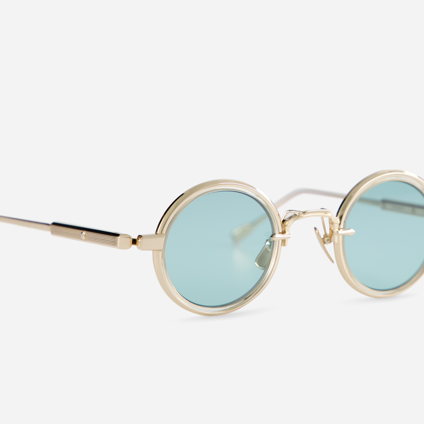 Rotanev-T LG-1 is designed with a titanium frame, lunar gold coating, honey yellow takiron rim insert, and turquoise lenses.