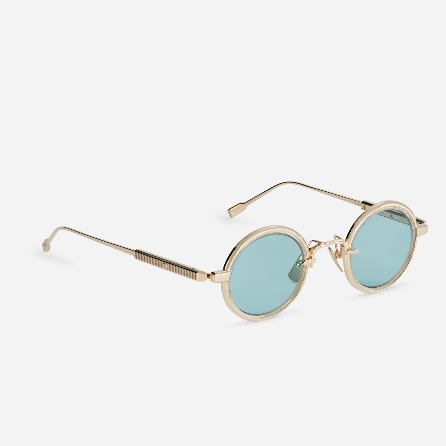 Rotanev-T LG-1 comes with a titanium frame, lunar gold coating, honey yellow takiron rim insert, and turquoise lenses.