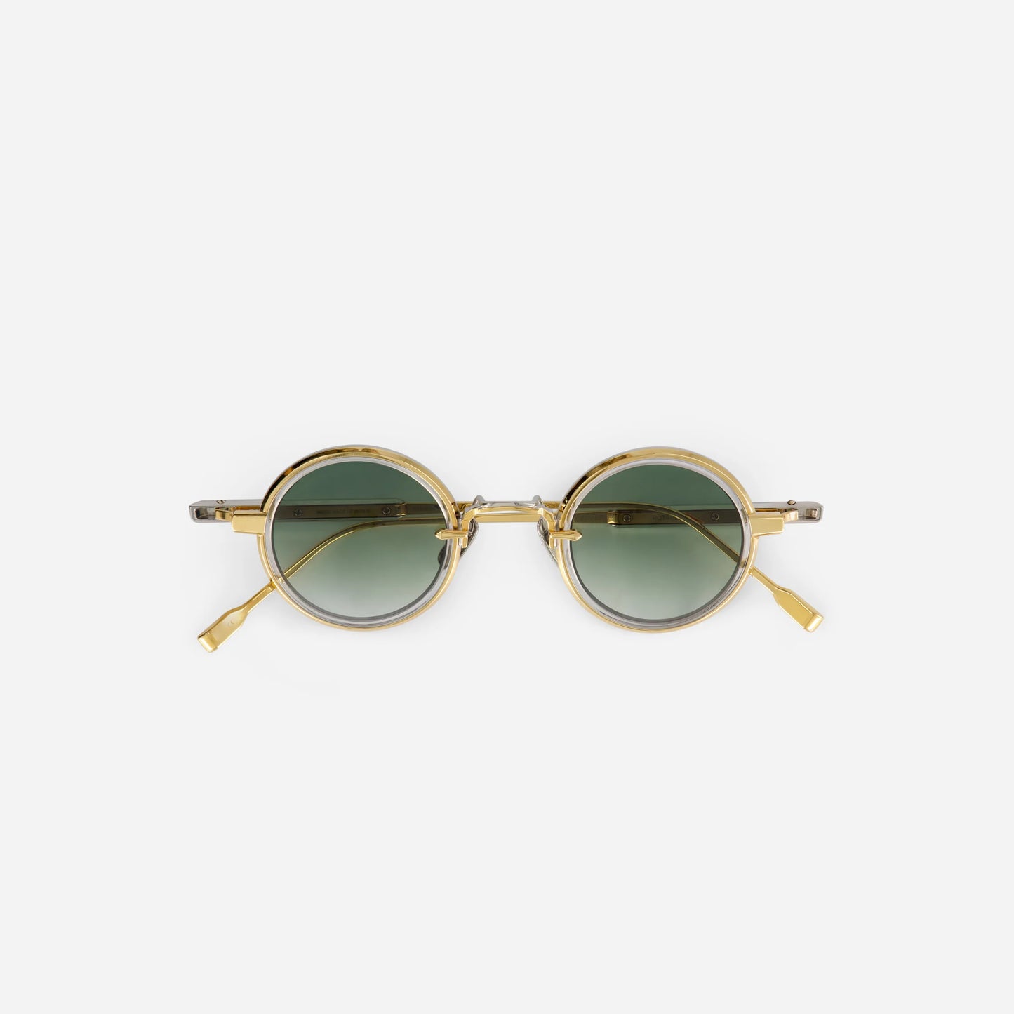 The Rotanev-T YG/P-1 features a titanium frame with yellow gold and platinum coatings, a crystal takiron rim insert, and gradient green lenses.