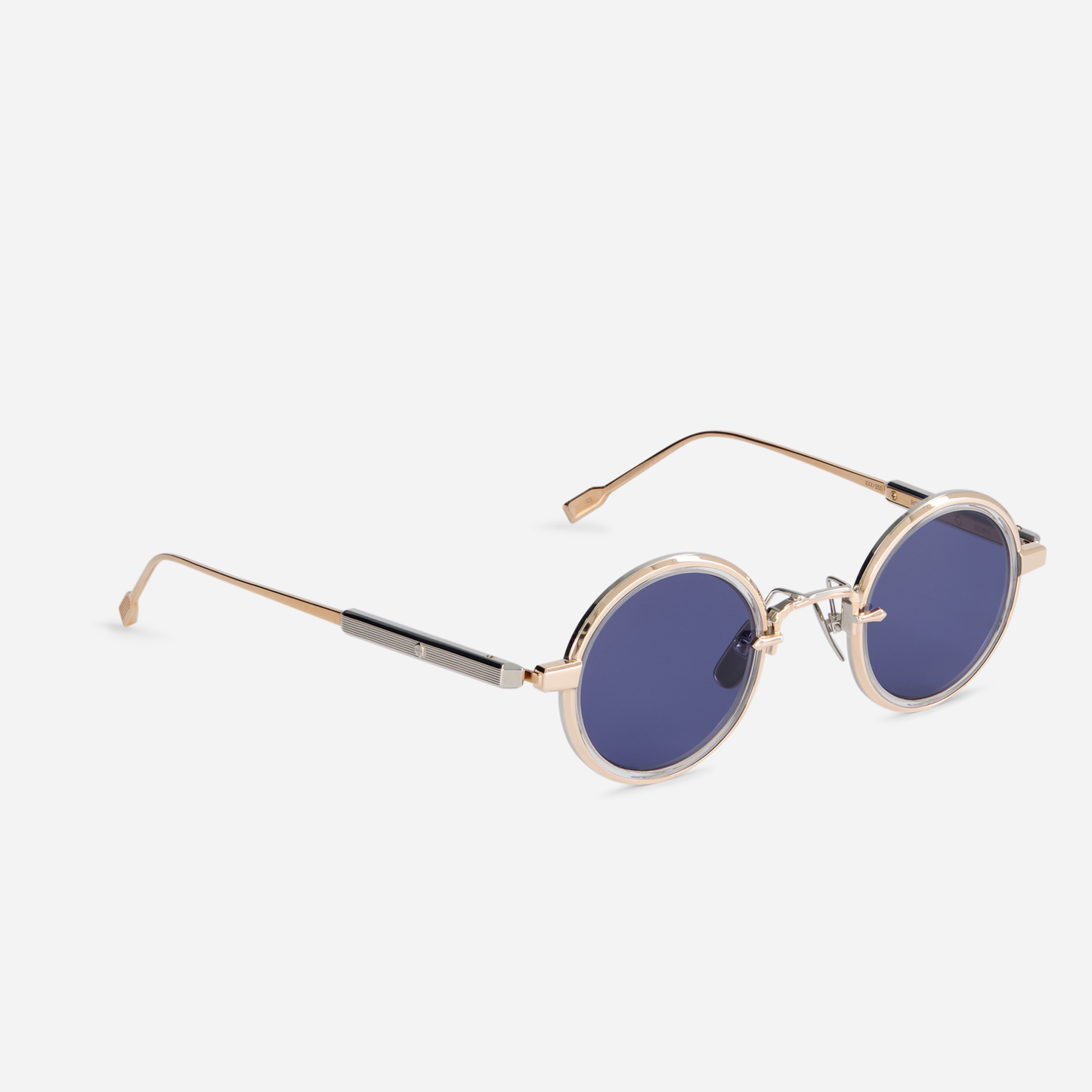 Rotanev-T RG/P-1 is designed with a titanium frame, rose gold, and platinum coating, crystal takiron rim insert, and BL-16 blue lenses.