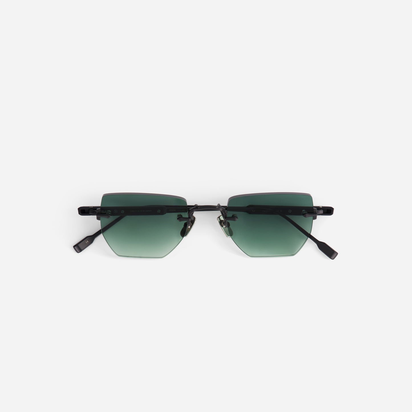 Sunglasses with green gradient lenses on a white background