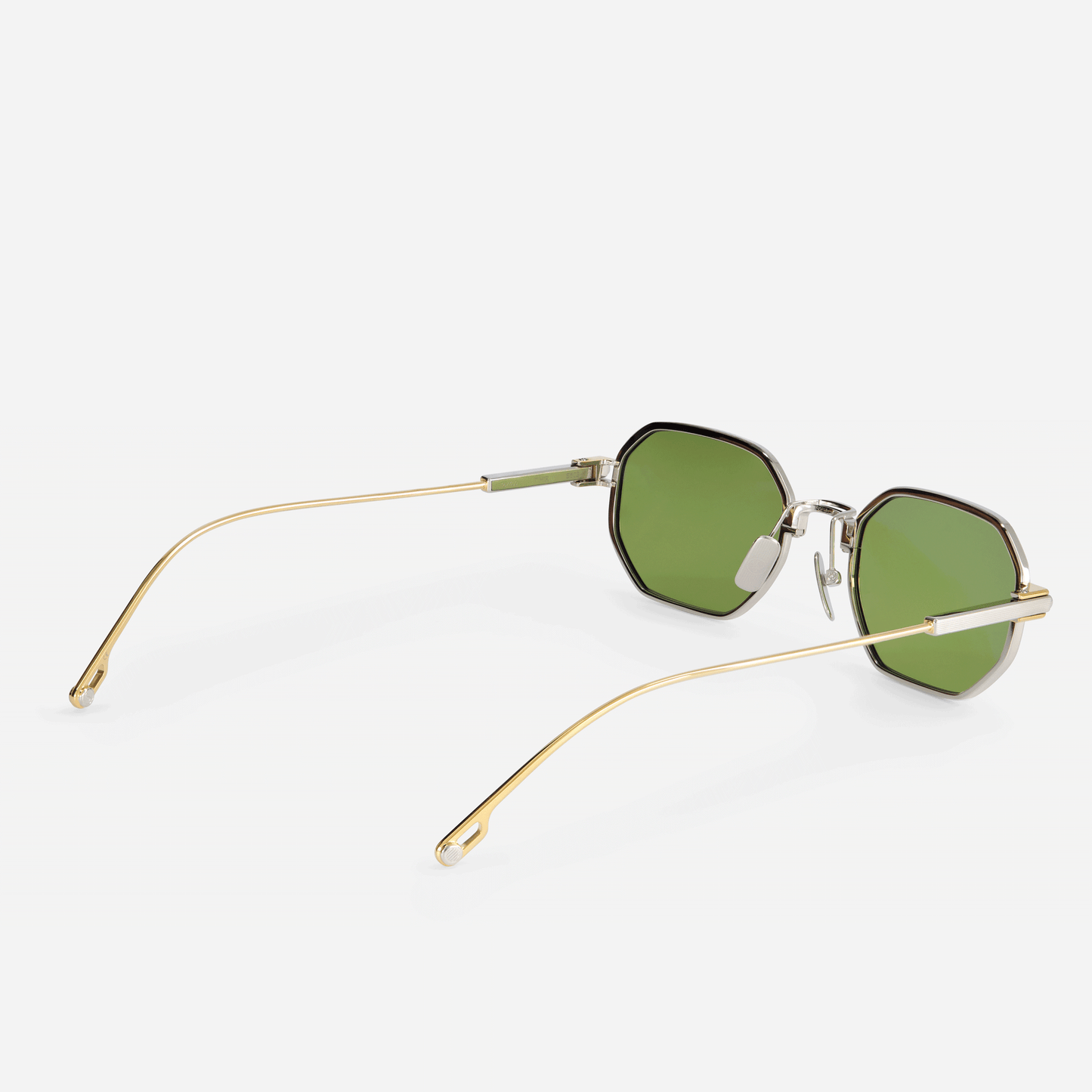 Timir S502 hexagonal glasses, flawlessly crafted from luxurious Japanese titanium in the Yellow Gold and Platinum finishes, paired with exquisite green lenses.