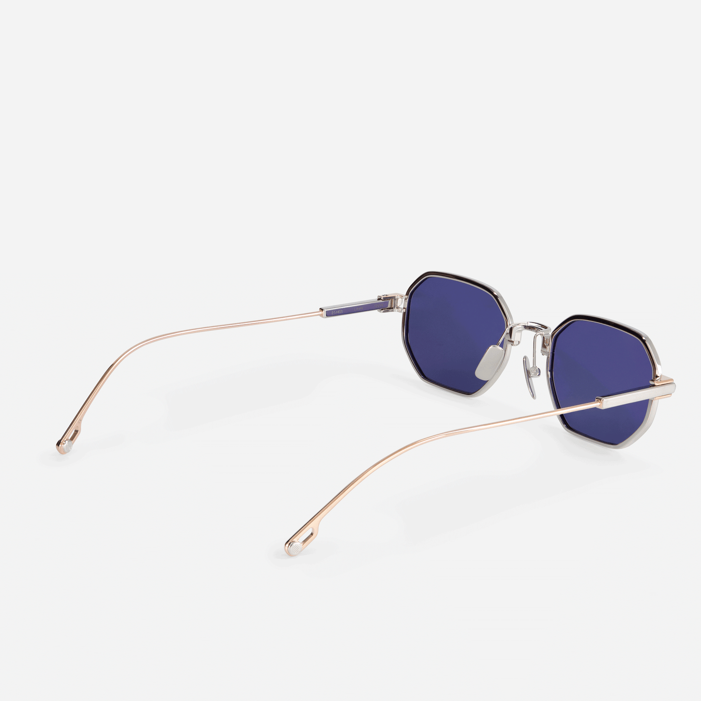 Timir S504 hexagonal glasses, a highlight from the latest Sato SS23 collection. Crafted from premium Japanese titanium in Rose Gold and Platinum, these glasses boast stylish blue-tinted lenses, perfect for men and women with a taste for sophistication.
