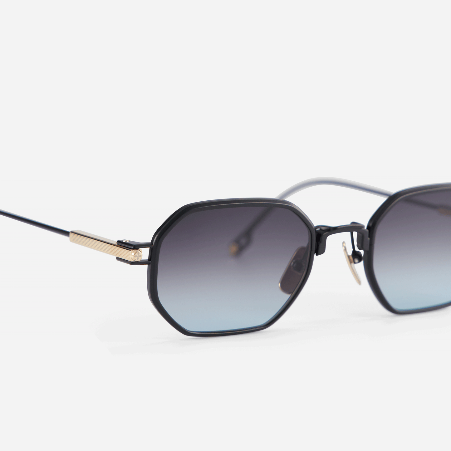 Timir S506 hexagonal glasses, featuring a limited edition black and palladium titanium frame. The sleek design is complemented by grey gradient tinted lenses.