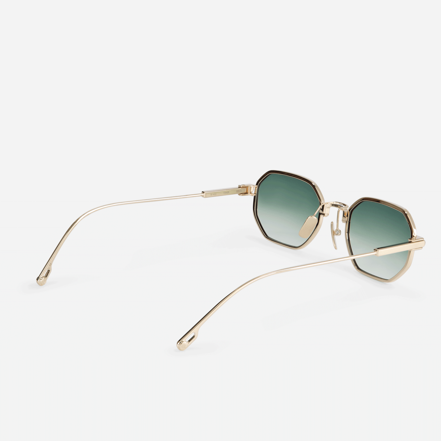 Timir S502 hexagonal glasses, expertly fashioned from luxurious Japanese titanium in the captivating Lunar Gold finish, accompanied by captivating olive gradient lenses.