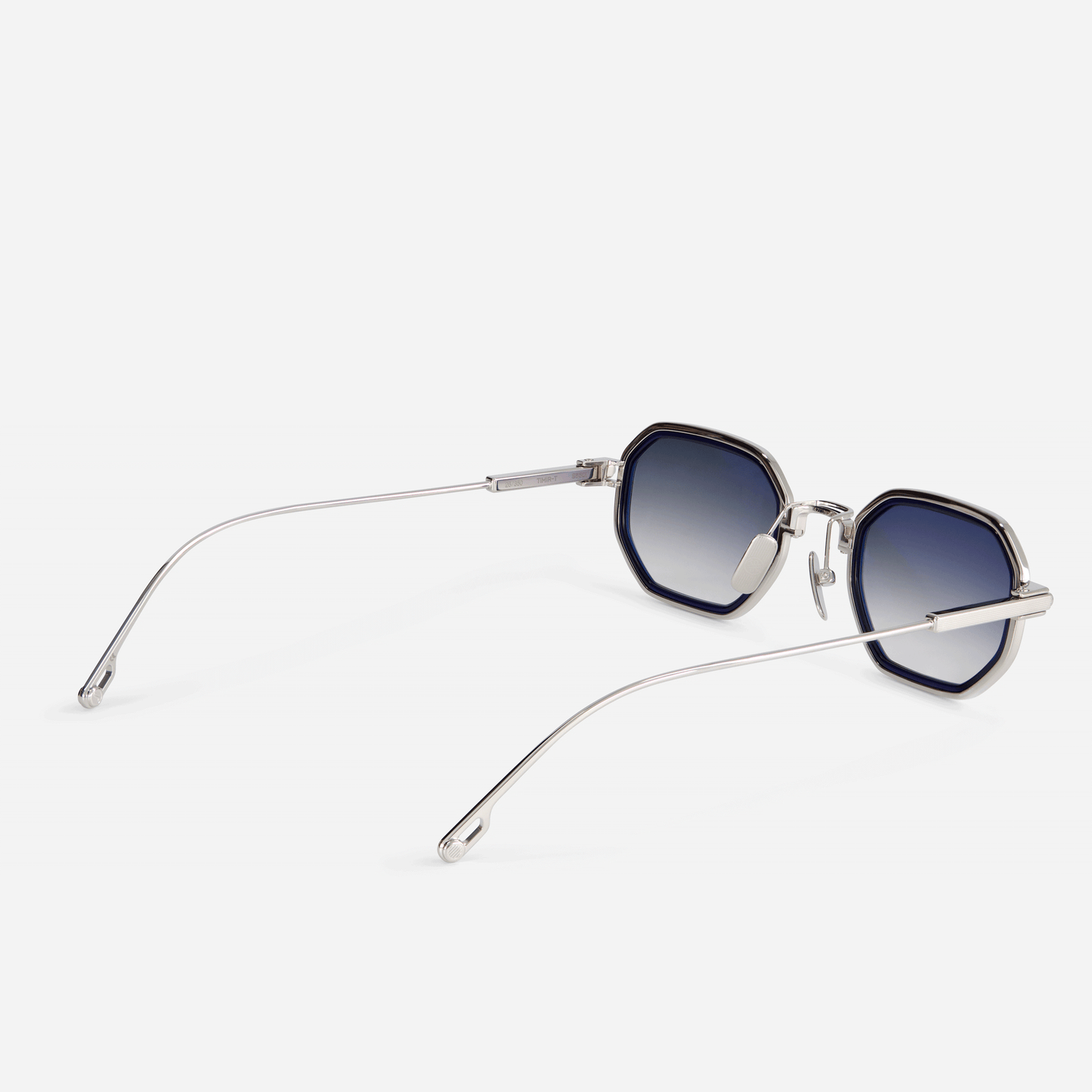 The limited edition Timir-T S5501 hexagonal glasses. , made from pure palladium titanium, is accentuated by alluring grey gradient tinted lenses and a stunning midnight blue Takiron insert.