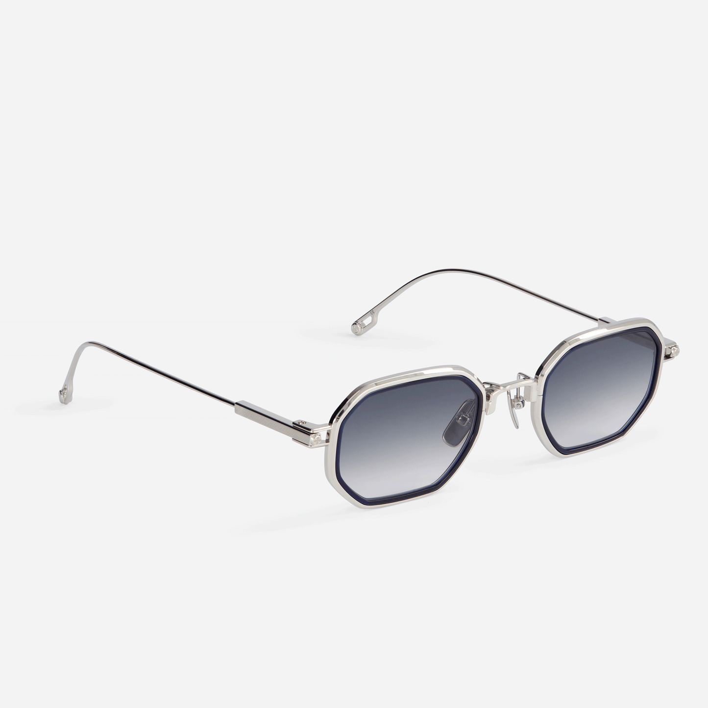 Limited edition Timir-T S5501 hexagonal glasses by Sato. These exceptional frames are meticulously crafted from pure palladium titanium, showcasing enchanting grey gradient tinted lenses and a captivating midnight blue Takiron insert.