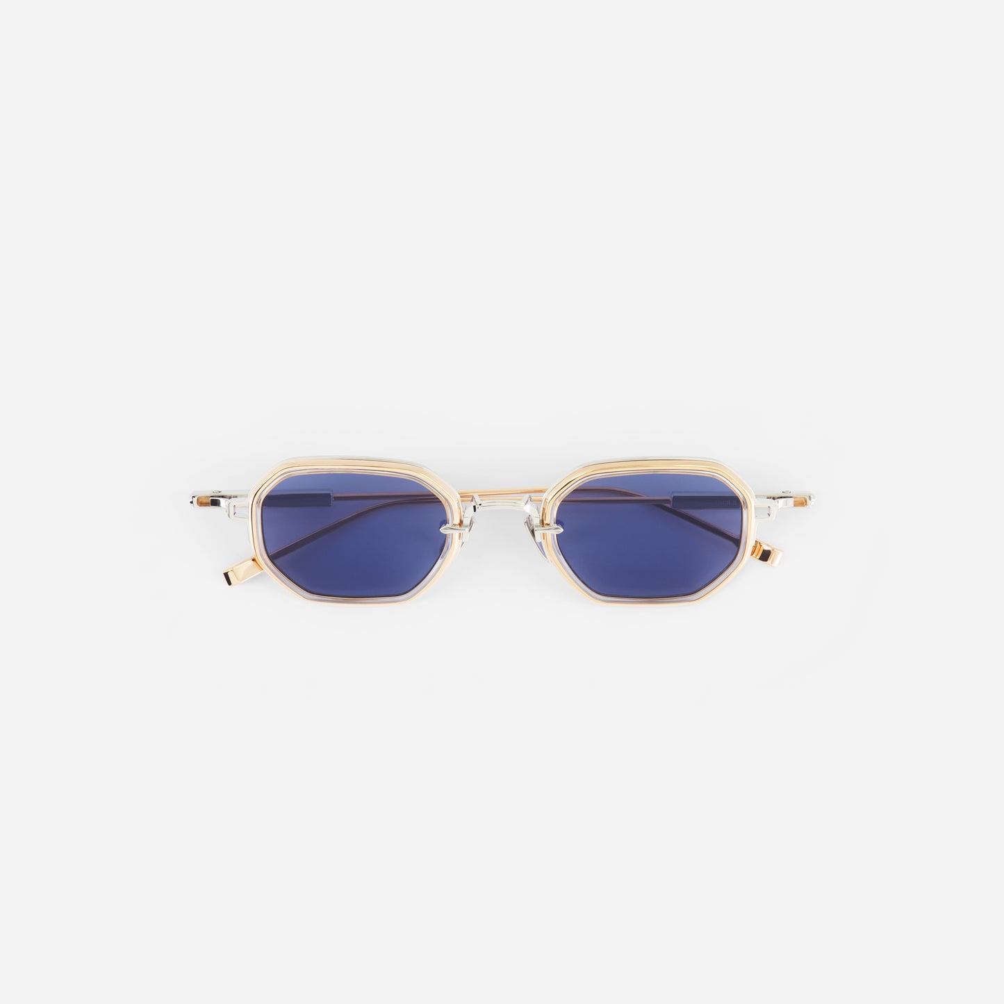 Gold-framed sunglasses with blue lenses on a white background