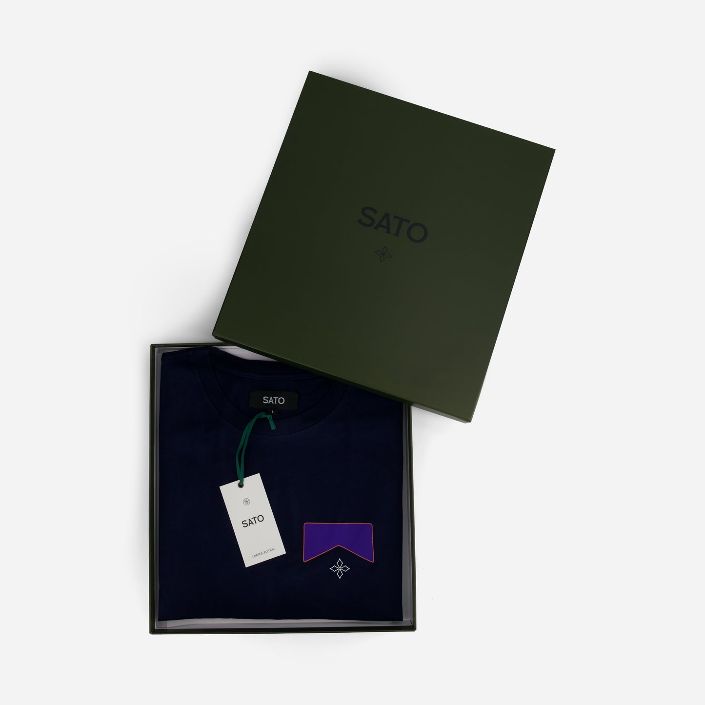 SATO branded box with a purple bow tie and tag on a white background