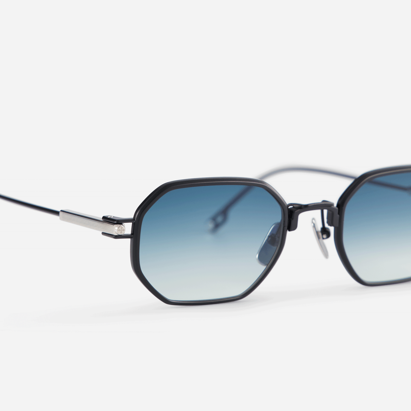 Timir S505 hexagonal glasses. Made from premium black titanium, these glasses showcase striking blue gradient tinted lenses, adding a touch of allure to the eyewear collection for both men and women.