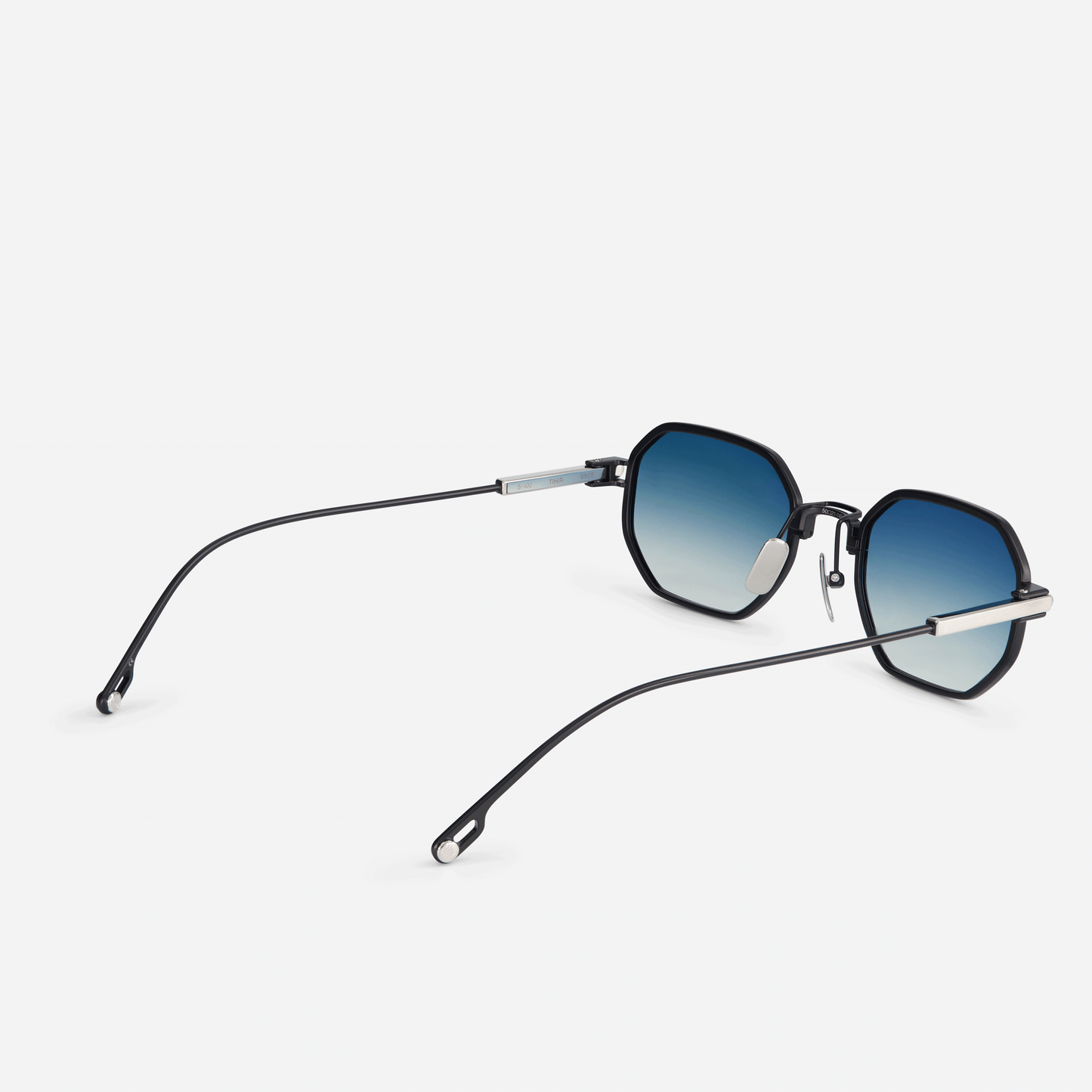 Timir S505 hexagonal glasses. Crafted from pure black titanium, these eyewear pieces feature trendy blue gradient tinted lenses, making them a perfect choice for fashion-forward men and women looking to make a statement. SATO