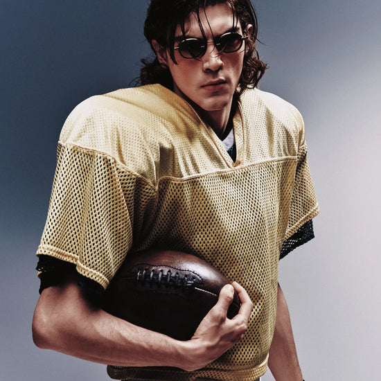 A man is wearing a pair of sunglasses on a blue white background