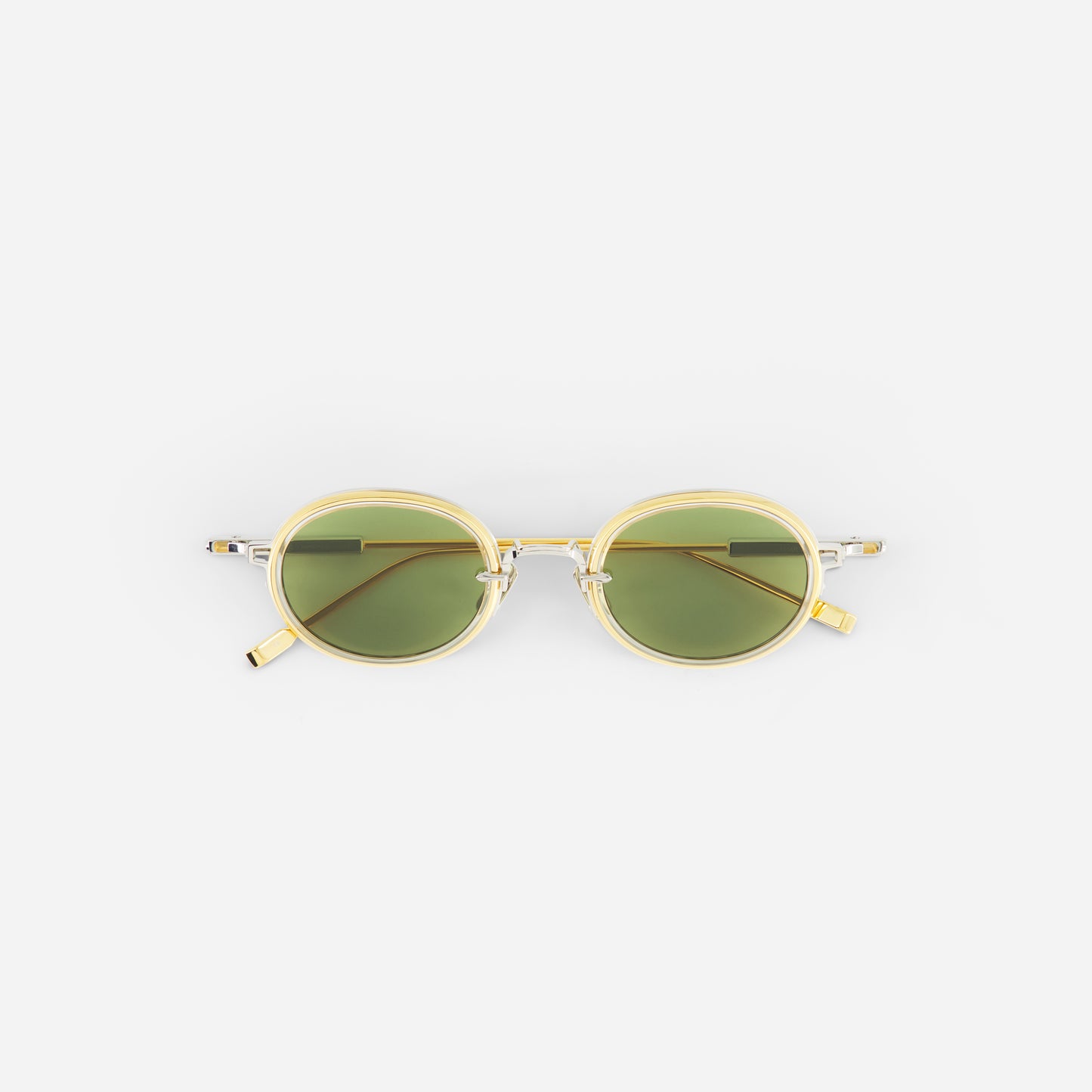 Round sunglasses with gold frame and green lenses on a white background
