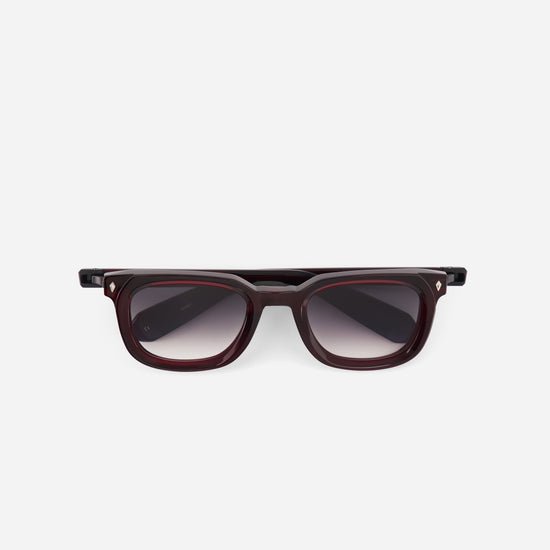 Sunglasses with a dark frame and gradient lenses on a white background