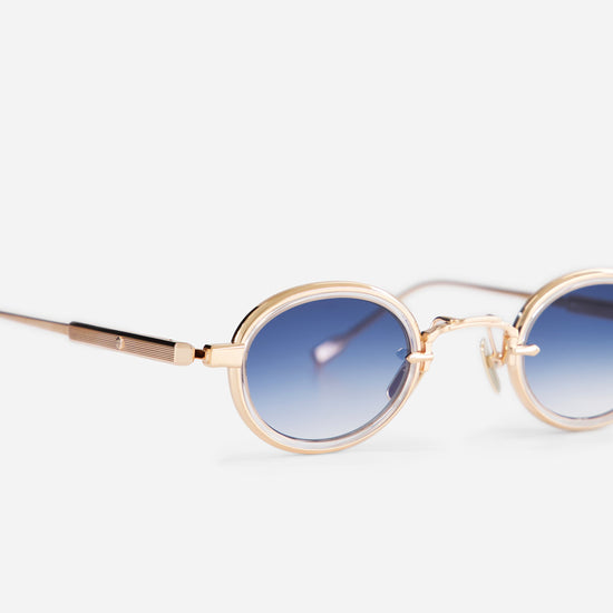 Algedi-T RG-1 features rose gold frames with a crystal insert and blue gradient lenses, made and numbered in Fukui