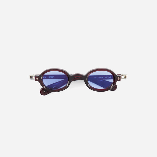 Round sunglasses with a dark red oval frame on a white background