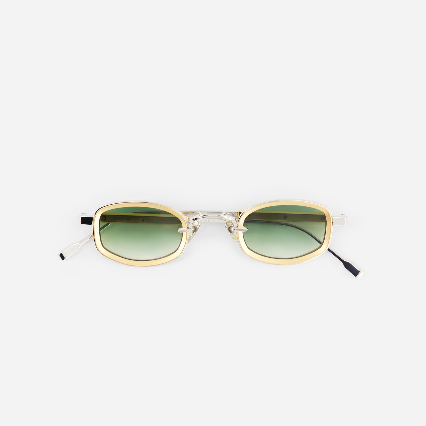 Sunglasses with gold frame and green gradient lenses on a white background