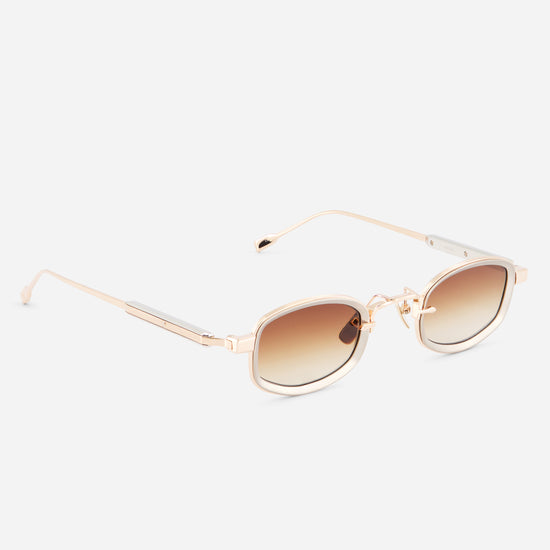 Gold-framed sunglasses with brown gradient lenses on a white background