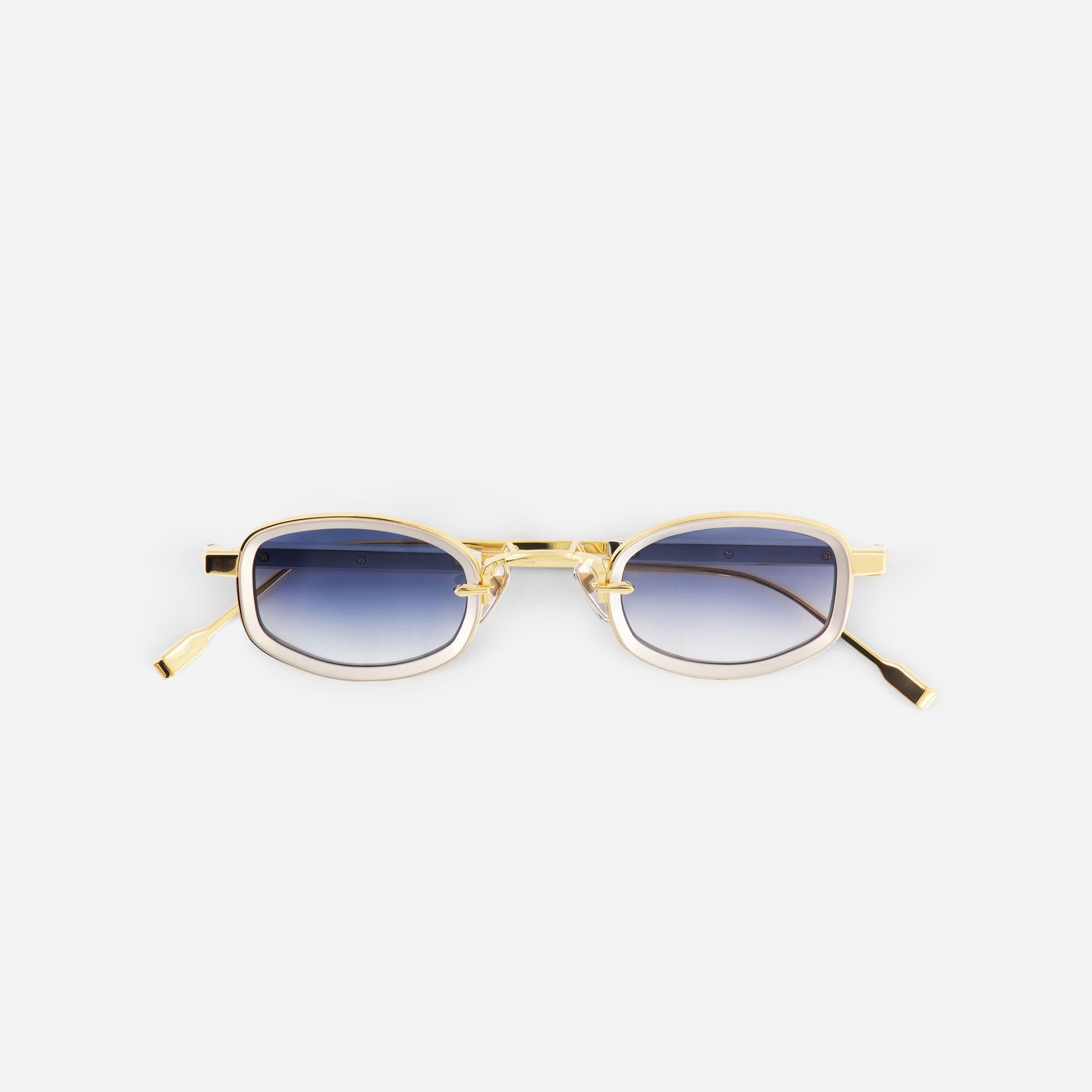Gold-framed sunglasses with gradient lenses on a white background