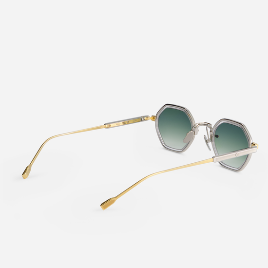 This eyewear, Sato Arraï-T YG/P-1, includes a titanium frame with a yellow gold and platinum coating, crystal takiron rim insert, and gradient green lens.