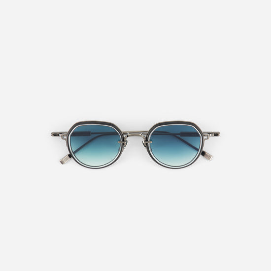 Round sunglasses with blue gradient lenses on a white background