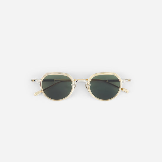 Sunglasses with gold frame and dark lenses on a white background