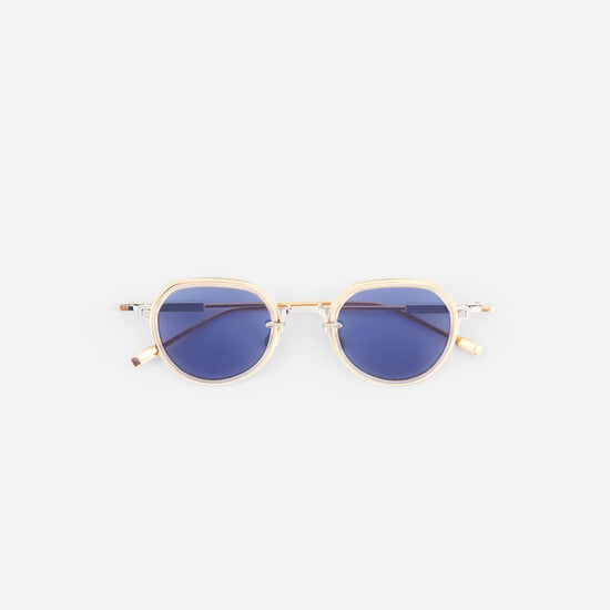 Gold-framed sunglasses with blue lenses on a white background