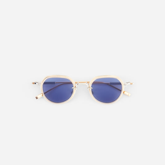 Gold-framed sunglasses with blue lenses on a white background