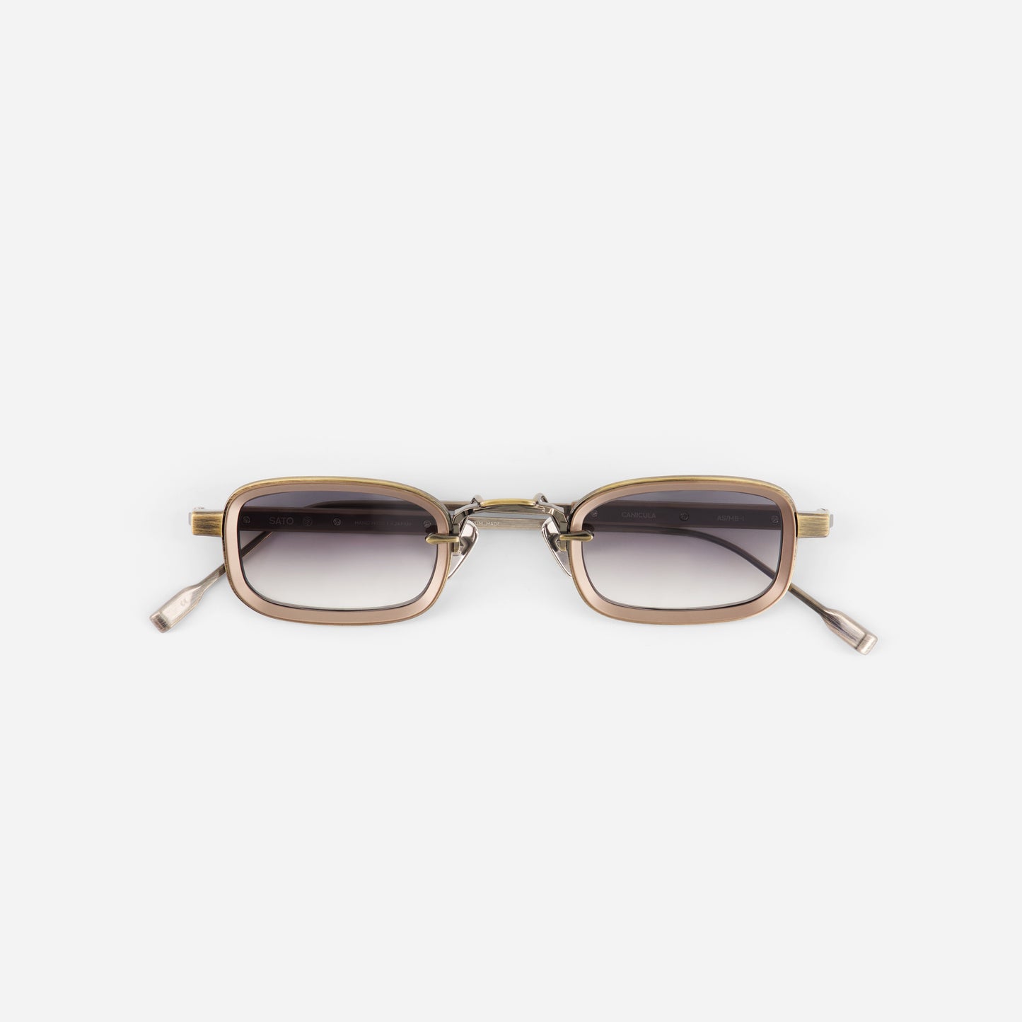 Sunglasses with gold frame and dark lenses on a white background