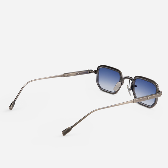 Manufactured in Japan, the Deneb-T AS-1 eyeglasses come with a titanium frame featuring an antique silver coating and crystal grey rim inserts. They also feature gradient blue lenses.