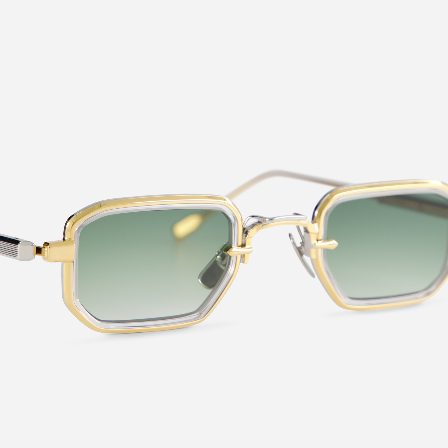 Featuring a titanium frame with yellow gold and platinum coatings, the Deneb-T YG/P-1 eyewear includes a crystal takiron rim insert and gradient green lenses.