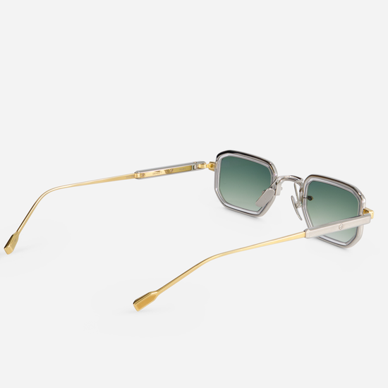The Deneb-T YG/P-1 eyeglasses are designed with a titanium frame, yellow gold, and platinum coating. They come with a crystal takiron rim insert and gradient green lenses.  SATO