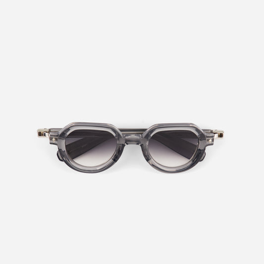 Crystal unglasses with a transparent frame and gradient grey lenses on a white background