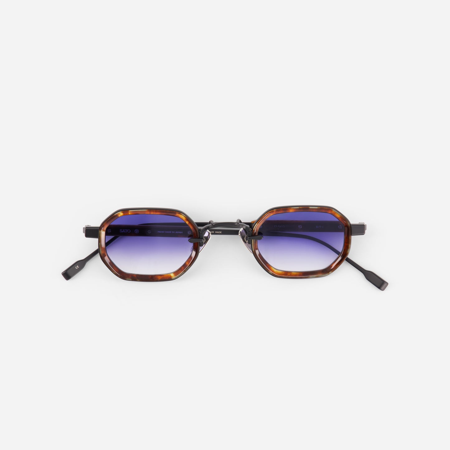 Sunglasses with tortoiseshell frame and gradient blue lenses on a white background