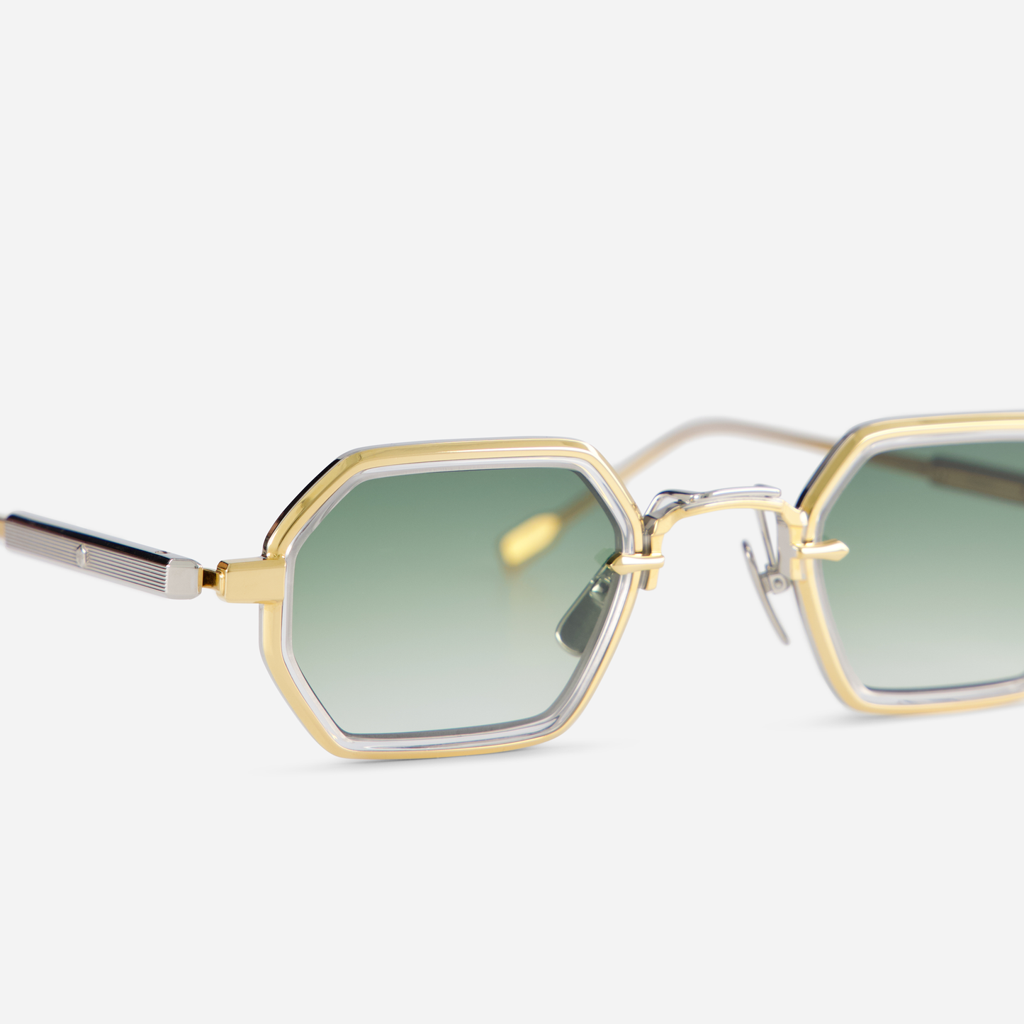 With a titanium frame accented by a yellow gold coating, the Hadar-T YG/P-1 eyewear incorporates a crystal takiron rim insert and gradient green lenses.
