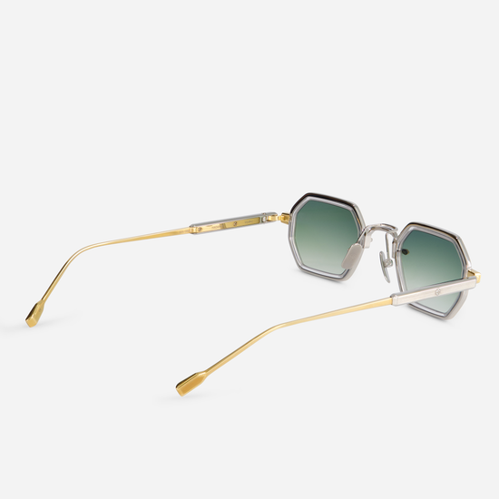 Hadar-T YG/P-1 showcases titanium-framed glasses with a yellow gold coating. These glasses also include a crystal takiron rim insert and gradient green lenses.