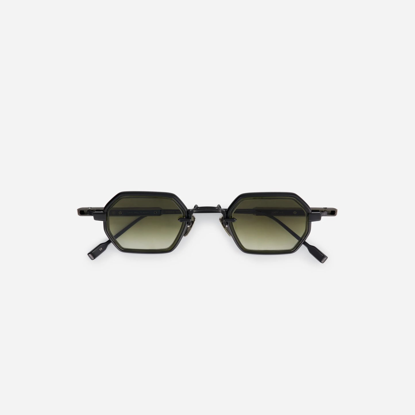 The Hadar-T B/AS-1 features a titanium frame with black mat and antique silver coating, a green olive takiron rim insert, and gradient green lenses.