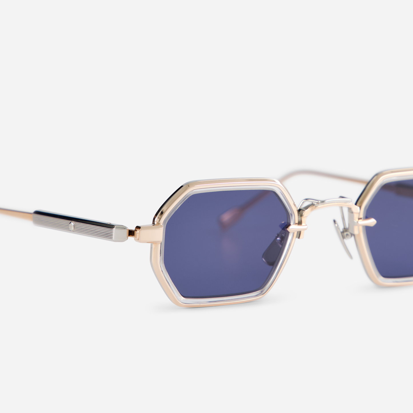 Crafted in Japan, the Hadar-T RG/P-1 showcases a titanium frame with a combination of rose gold and platinum coatings, accented by crystal takiron rim inserts. The eyewear is designed with BL-16 blue lenses for a unique look.