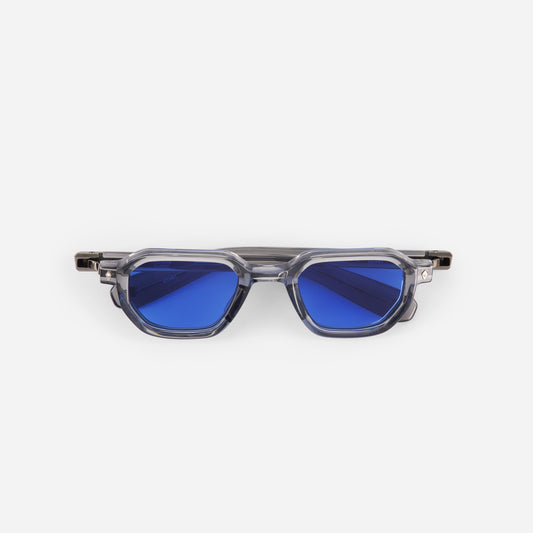 Crystal sunglasses with blue lenses and transparent frame on a white background