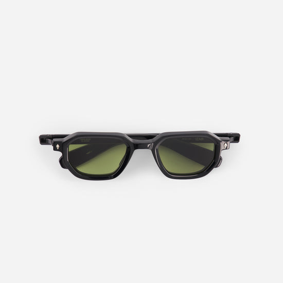 Black sunglasses with green lenses on a white background